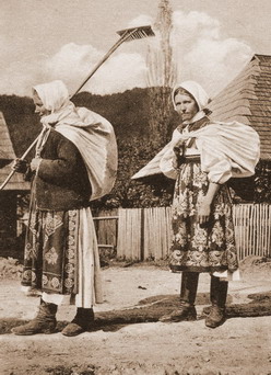 Two women of Slovak village Zaskov going to a field